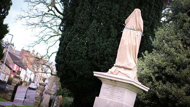 The newly restored statue of Nethaniel Ireson in the grounds of Wincanton Parish Church, still covered