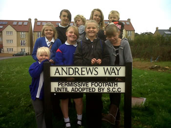 Local kids gathered around the sign for the New Barns path, Andrews Way