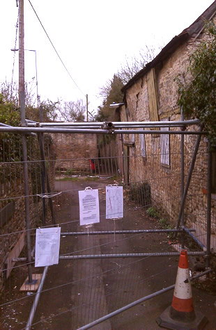 Before the repair, railings up with Council notice