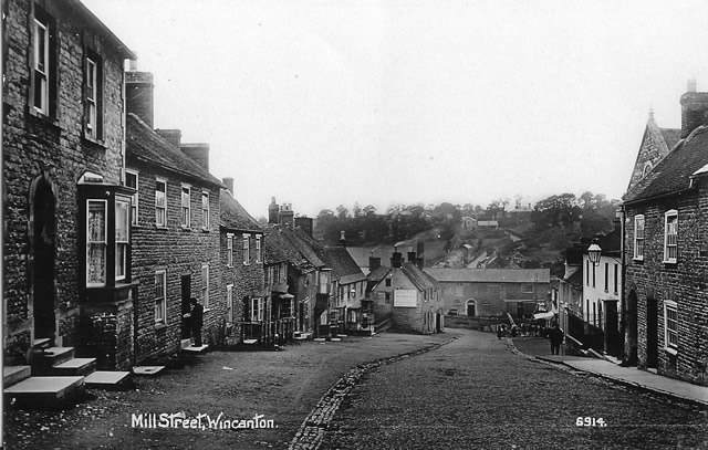 Looking down Mill Street towards the old workhouse. A postman can been seen delivering mail on the left. circ 1910.