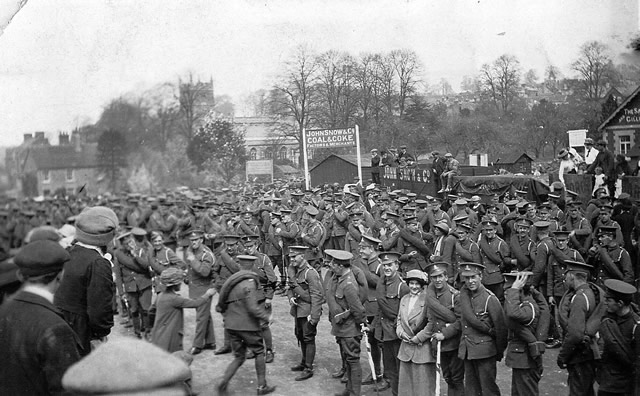Soldiers saying their goodbyes as they leave Wincanton station for the front line in France WW1. In the background can be seen the Parish Church.